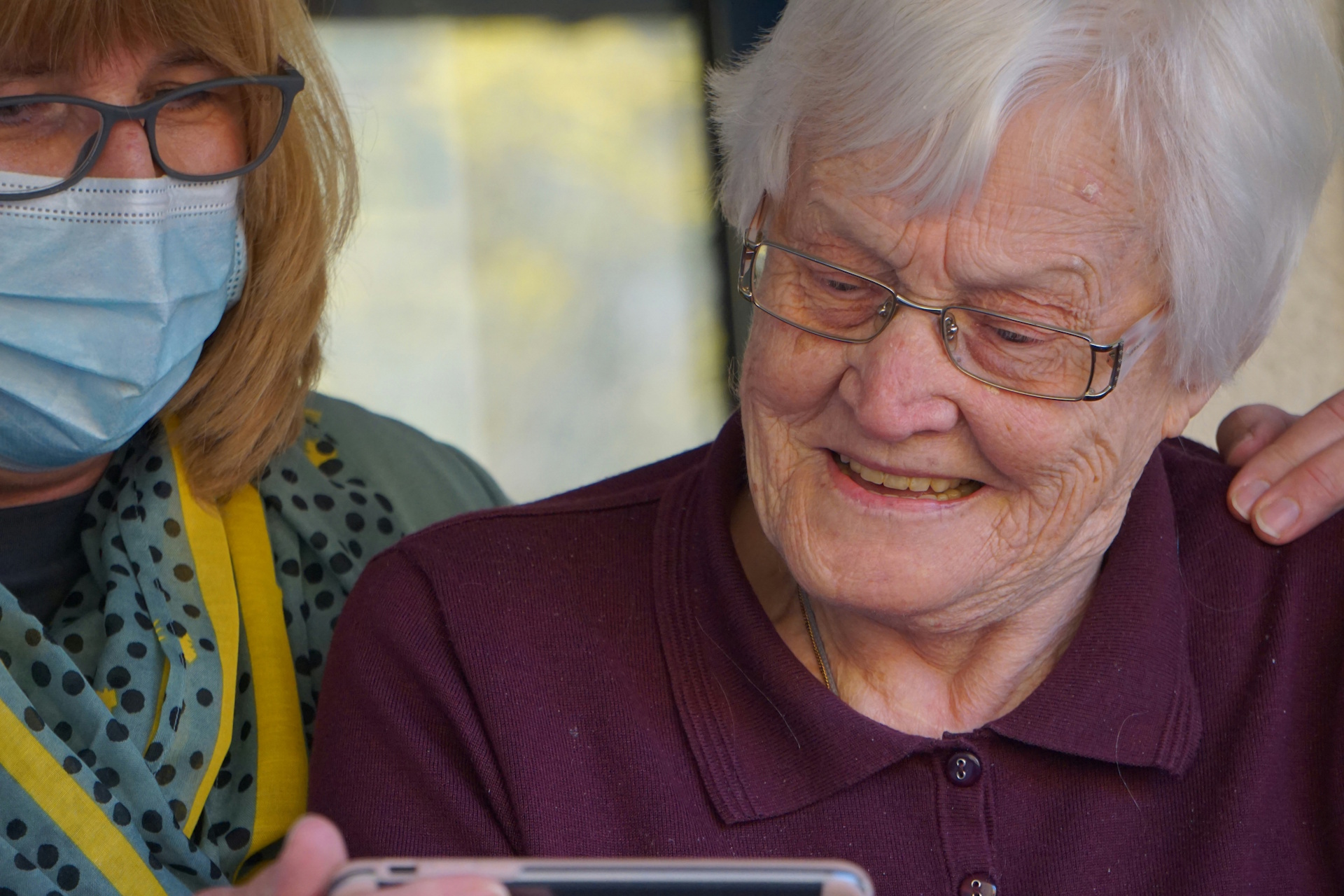 Carer with an elderly resident smiling together